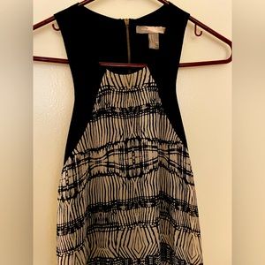 Short, backless dress with geometric design. Black and Tan.